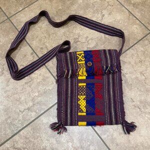 purple striped crossbody bag with tassel details